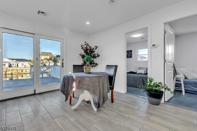 dining area featuring plenty of natural light and light hardwood / wood-style floors