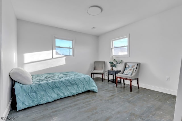 bedroom featuring wood-type flooring and multiple windows