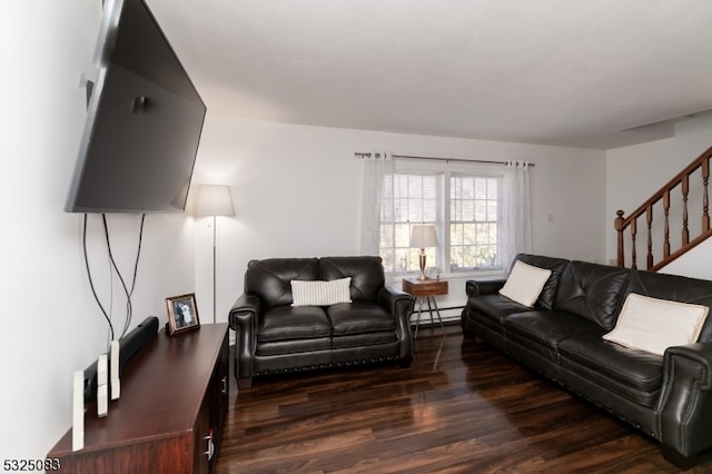 living room featuring baseboard heating and dark hardwood / wood-style floors