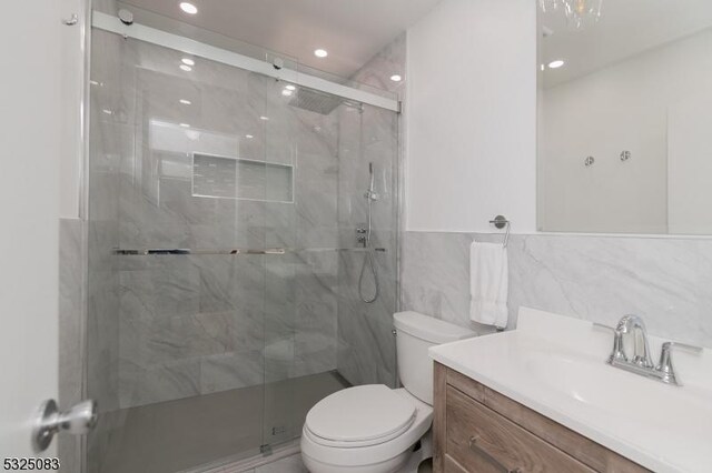 203 E Main St, Prospect Park Boro, NJ 07508 - bathroom featuring toilet, vanity, a stall shower, tile walls, and recessed lighting