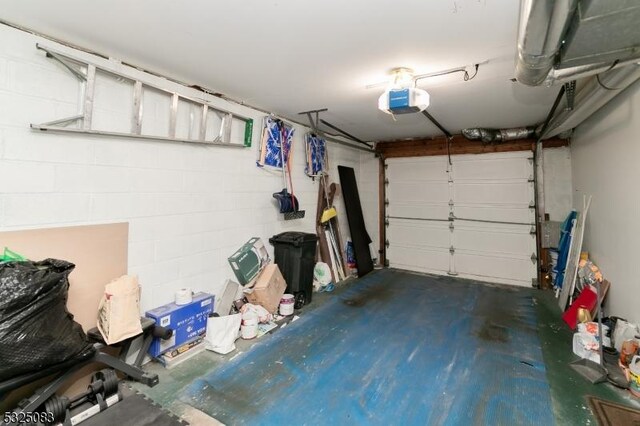 203 E Main St, Prospect Park Boro, NJ 07508 - garage featuring a garage door opener and concrete block wall