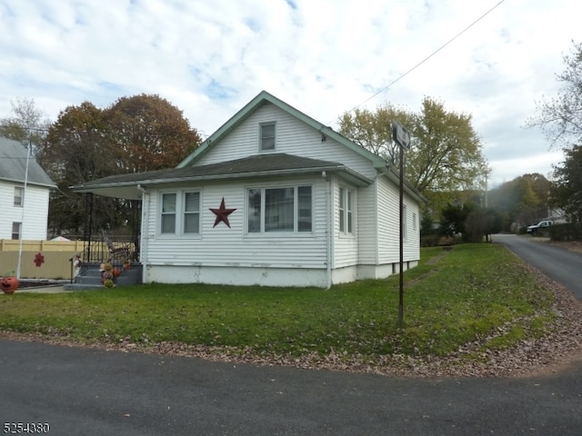 view of side of home featuring a lawn