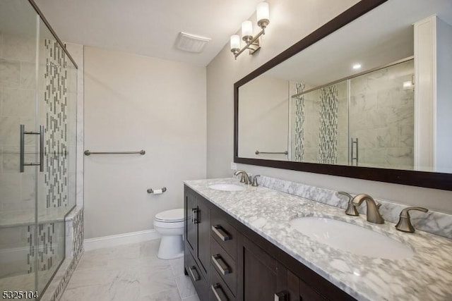 bathroom featuring vanity, toilet, and a shower with shower door