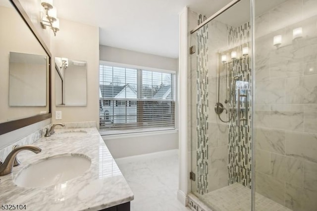 bathroom featuring vanity and a shower with shower door