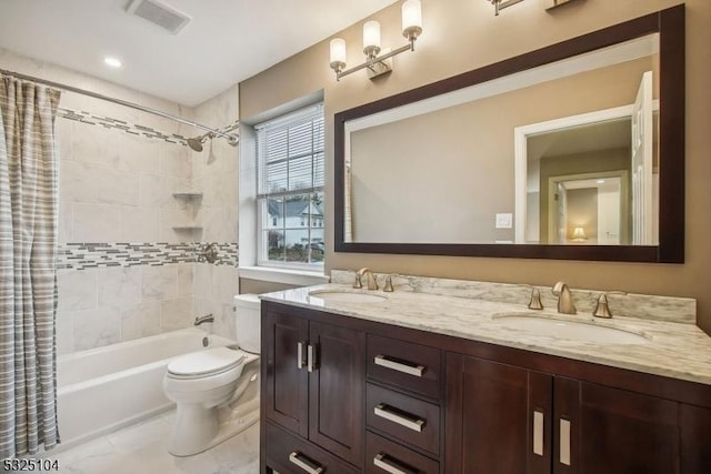 full bathroom with shower / bath combination with curtain, vanity, and toilet