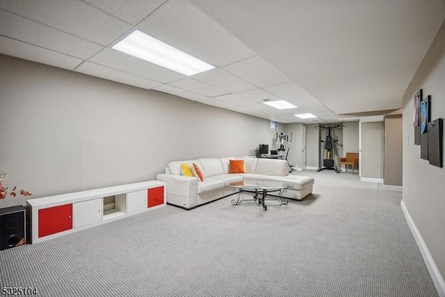 living room featuring carpet flooring and a paneled ceiling