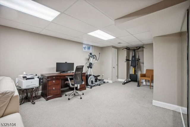 carpeted office featuring a paneled ceiling