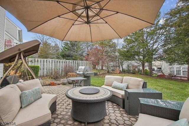 view of patio with an outdoor living space and a grill