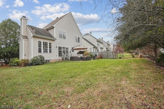 rear view of property with a lawn