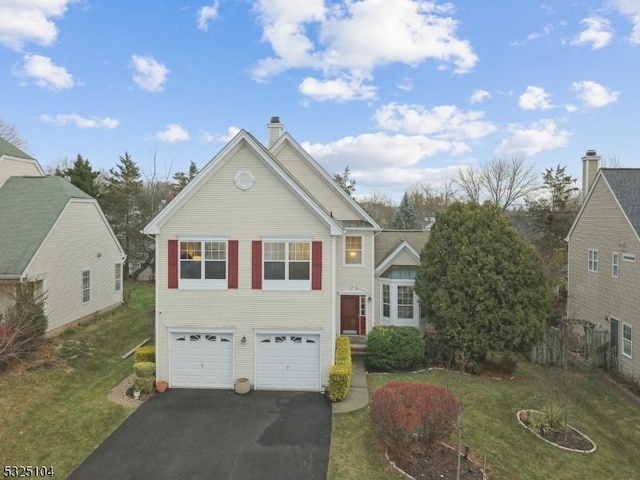 view of front of property featuring a garage and a front yard