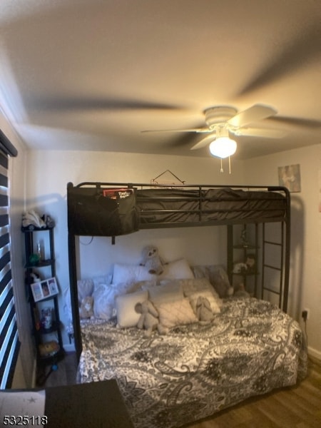 bedroom with ceiling fan and hardwood / wood-style flooring