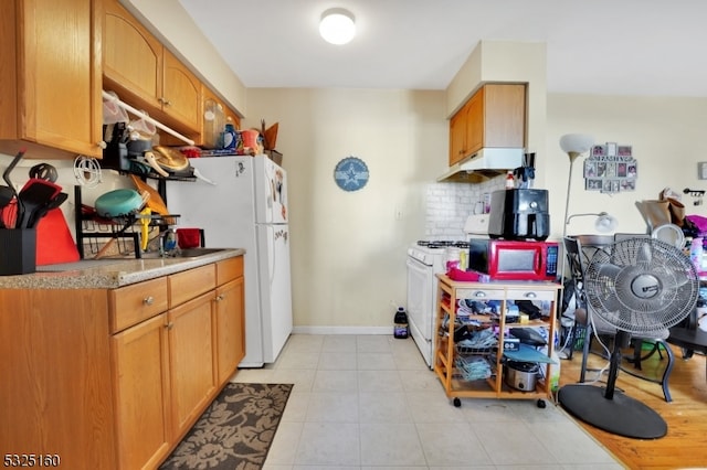 kitchen with decorative backsplash and white appliances