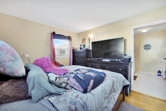 bedroom featuring cooling unit and light hardwood / wood-style flooring