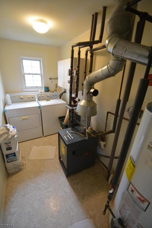 laundry room featuring washer and clothes dryer, light tile patterned flooring, and gas water heater