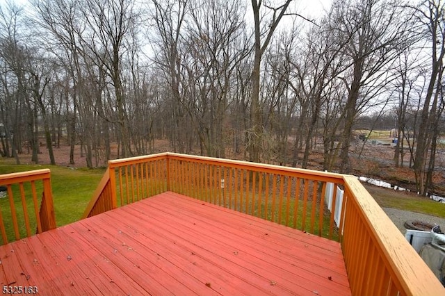 wooden deck featuring a lawn