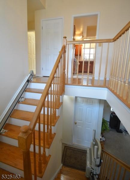 stairs with hardwood / wood-style flooring