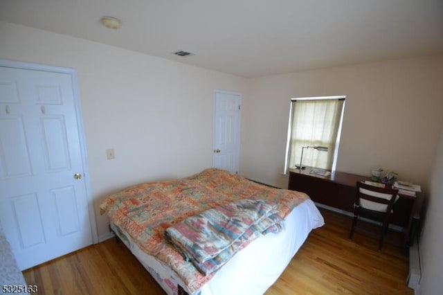 bedroom with hardwood / wood-style floors