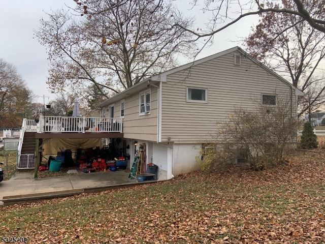 view of side of property with a deck and a garage