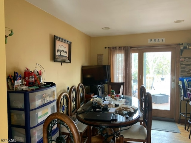 dining room with light hardwood / wood-style floors and a wealth of natural light