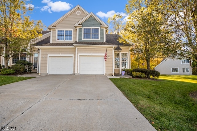 view of front of property with a front yard and a garage