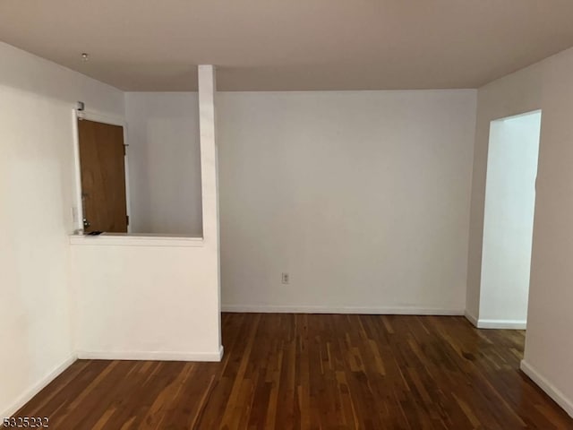 spare room with dark hardwood / wood-style floors