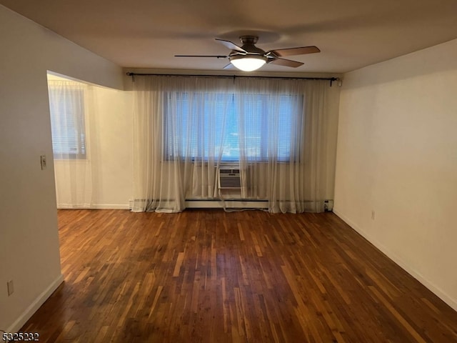 empty room with ceiling fan, cooling unit, dark hardwood / wood-style flooring, and baseboard heating