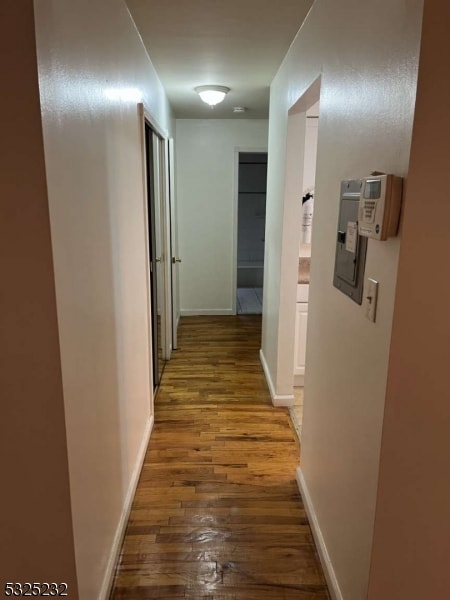 hall with dark wood-type flooring