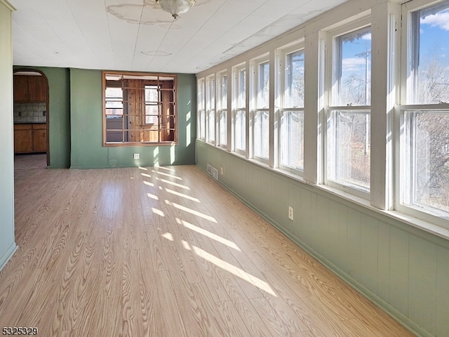 unfurnished sunroom featuring plenty of natural light