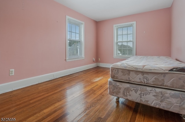 bedroom with hardwood / wood-style flooring