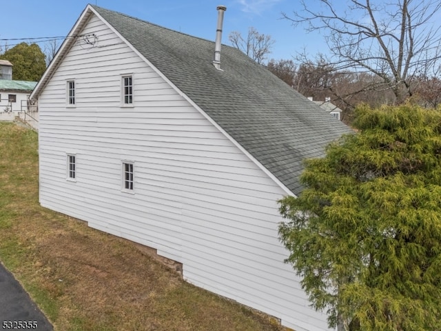 view of property exterior featuring a lawn