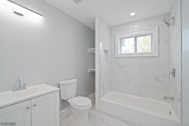 full bathroom with vanity, tiled shower / bath combo, and toilet