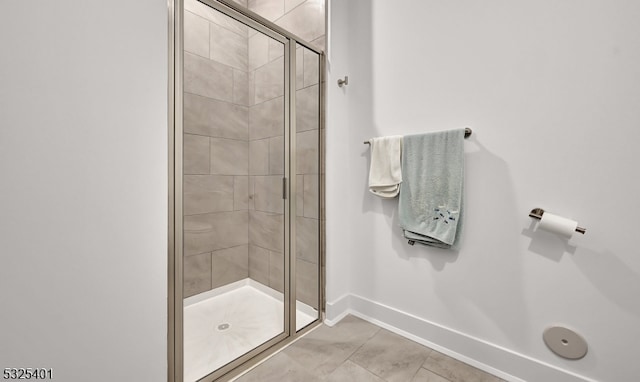 bathroom featuring tile patterned floors and a shower with shower door