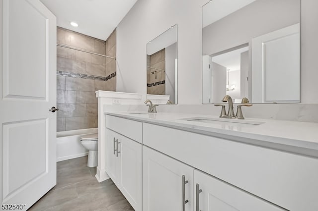 full bathroom featuring tile patterned floors, vanity, toilet, and tiled shower / bath