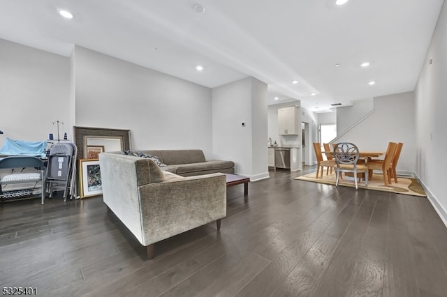 living room with dark hardwood / wood-style flooring