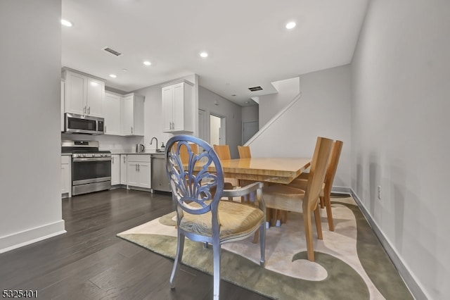 dining room with dark hardwood / wood-style floors