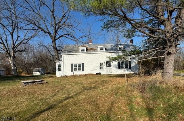 back of house with a lawn