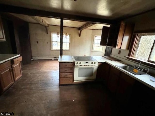 kitchen with baseboard heating, sink, beamed ceiling, and white stove