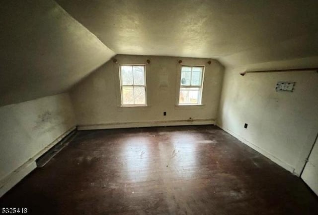 bonus room featuring dark hardwood / wood-style flooring and lofted ceiling