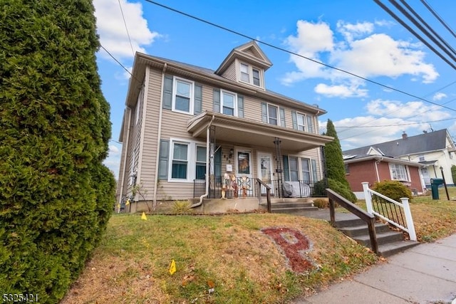 view of front of property with covered porch and a front lawn