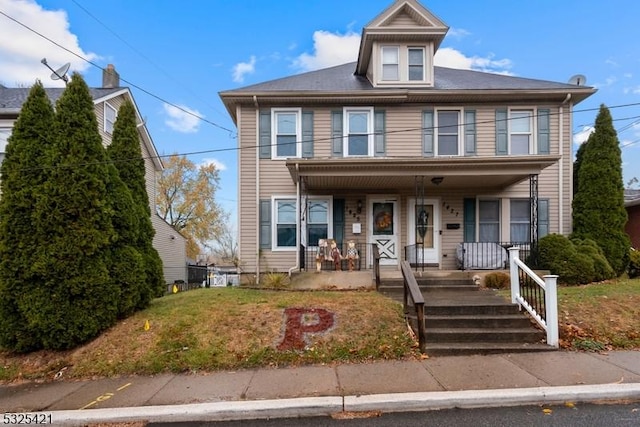 view of front of home featuring a front yard and covered porch