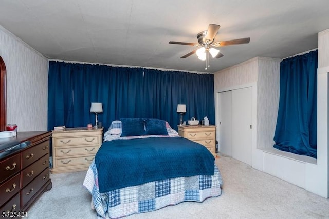 bedroom featuring ceiling fan, a closet, and light carpet