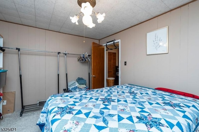 carpeted bedroom with a chandelier