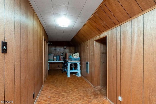 hallway with wood walls