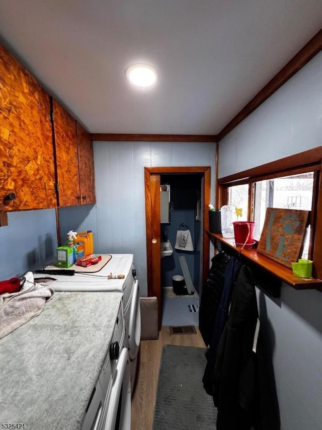 kitchen featuring hardwood / wood-style floors and washer / dryer