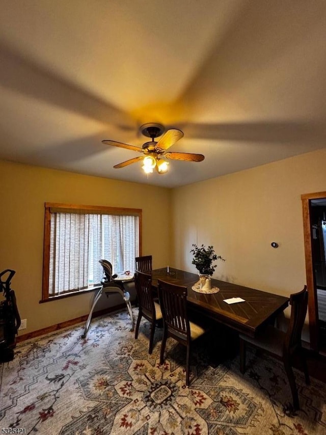 carpeted dining area featuring ceiling fan