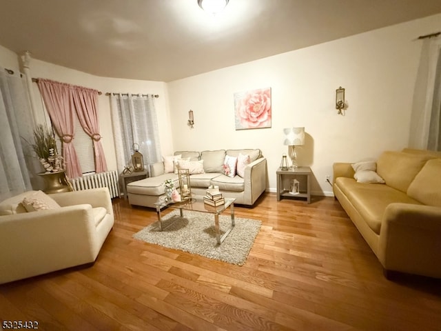 living room featuring radiator heating unit and wood-type flooring