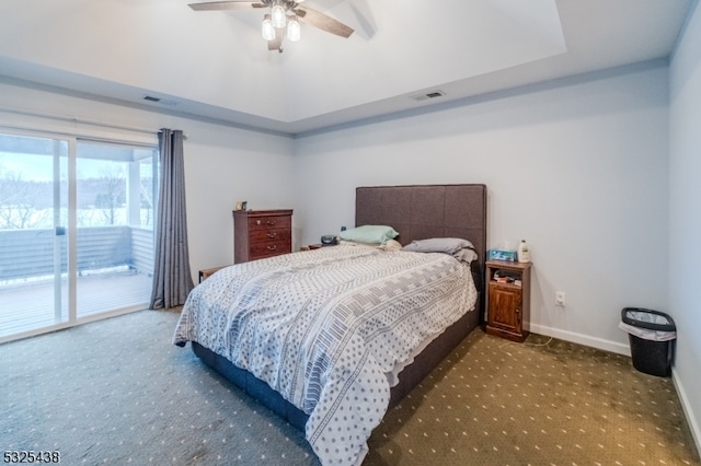 carpeted bedroom featuring access to outside, ceiling fan, and a tray ceiling