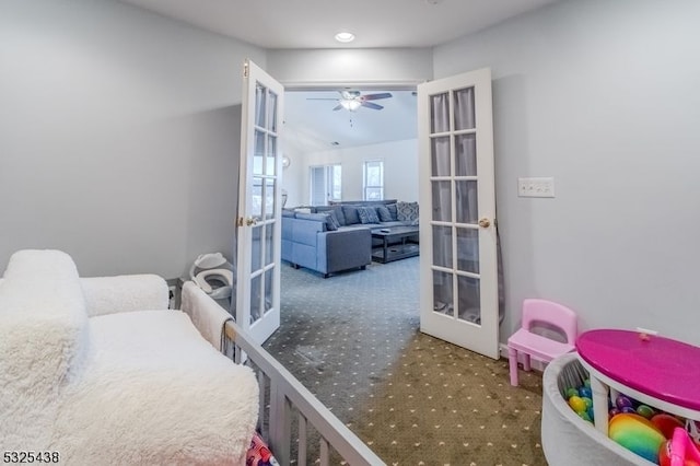 carpeted bedroom featuring ceiling fan, french doors, and lofted ceiling