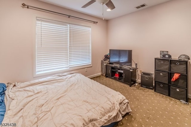 bedroom with carpet, ceiling fan, and multiple windows