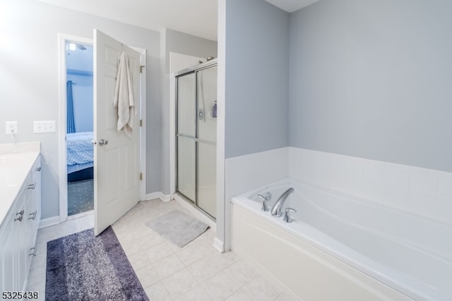 bathroom featuring shower with separate bathtub, vanity, and tile patterned floors